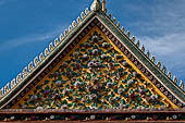 Bangkok Wat Arun - Detail of the decoration of the gable of the entrance of the Ubosot. 